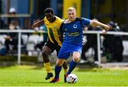 19 July 2020; Sean Byrne of Bluebell United in action against George Mukete of Ballymun United during the Leinster Senior League Senior Sunday Division match between Bluebell United and Ballymun United at Capco Park in Bluebell, Dublin.  Photo by Sam Barnes/Sportsfile