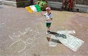 21 July 2020; Conor Carroll, age 3, a resident of Iveagh Trust Kevin Street in Dublin, during a rememberance for Jack Charlton on the day of his funeral in Newcastle, England. The former Republic of Ireland manager Jack Charlton lead the Republic of Ireland team to their first major finals at UEFA Euro 1988, and subsequently the FIFA World Cup 1990, in Italy, and the FIFA World Cup 1994, in USA.  Photo by Stephen McCarthy/Sportsfile