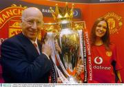 7 January 2004; Sir Bobby Charlton with model Roberta Rowat, with the Barclaycard Premiership trophy, at the launch of the Manchester United Barclaycard credit card onto the Irish market. Jervis Shopping Centre, Dublin. Picture credit; David Maher / SPORTSFILE *EDI*