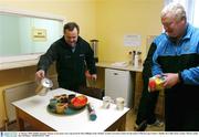 11 January 2004; Dublin manager Tommy Lyons pours out a cup of tea for Dave Billings in the 'kitchen' on their arrival in Carlow for the match. O'Byrne Cup, Carlow v Dublin, Dr Cullen Park, Carlow. Picture credit; Ray McManus / SPORTSFILE *EDI*