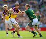 30 June 2013; Redmond Barry, the Wexford captain, is tackled by the Meath captain Kevin Reilly. Leinster GAA Football Senior Championship, Semi-Final, Meath v Wexford, Croke Park, Dublin. Picture credit: Ray McManus / SPORTSFILE