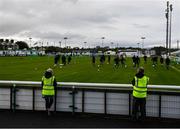 24 July 2020; Club stewards Catherine Moran and Paddy Gormley watch the Waterford players warm up ahead of the club friendly match between Bray Wanderers and Waterford at Carlisle Grounds in Bray, Wicklow. Soccer matches continue to take place in front of a limited number of people in an effort to contain the spread of the coronavirus (Covid-19) pandemic. Photo by Eóin Noonan/Sportsfile