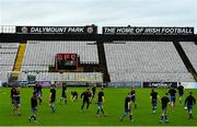 24 July 2020; The Longford Town squad warm-up in front of a cordoned off substitutes bench ahead of the club friendly match between Bohemians and Longford Town at Dalymount Park in Dublin. Soccer matches continue to take place in front of a limited number of people in an effort to contain the spread of the coronavirus (Covid-19) pandemic. Photo by Ramsey Cardy/Sportsfile