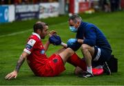24 July 2020; Karl Sheppard of Shelbourne receives treatment from Shelbourne physio Alan Dooley during the club friendly match between Shelbourne and Linfield at Tolka Park in Dublin. Soccer matches continue to take place in front of a limited number of people in an effort to contain the spread of the coronavirus (Covid-19) pandemic. Photo by Harry Murphy/Sportsfile