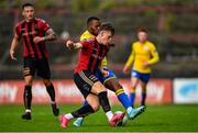 24 July 2020; Andy Lyons of Bohemians in action against Lido Lotefa of Longford Town during the club friendly match between Bohemians and Longford Town at Dalymount Park in Dublin. Soccer matches continue to take place in front of a limited number of people in an effort to contain the spread of the coronavirus (Covid-19) pandemic. Photo by Ramsey Cardy/Sportsfile