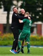 26 July 2020; Graham Curran of Usher Celtic, 2, celebrates after scoring his side's first goal with Usher Celtic manager Wesley Doyle, centre, and backroom staff during the FAI New Balance Junior Cup Quarter-Final match between Usher Celtic and Gorey Rangers at Grangegorman IT in Dublin. Competitive Soccer matches have been approved to return following the guidelines of Phase 3 of the Irish Government’s Roadmap for Reopening of Society and Business and protocols set down by the Soccer governing authorities. With games having been suspended since March, competitive games can take place with updated protocols including a limit of 200 individuals at any one outdoor event, including players, officials and a limited number of spectators, with social distancing, hand sanitisation and face masks being worn by those in attendance among other measures in an effort to contain the spread of the Coronavirus (COVID-19). Photo by Sam Barnes/Sportsfile
