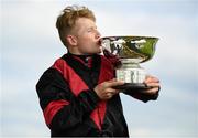 28 July 2020; Jockey Gavin Ryan celebrates with the trophy after victory in the COLM QUINN BMW Mile Handicap on Saltonstall during day two of the Galway Summer Racing Festival at Ballybrit Racecourse in Galway. Horse racing remains behind closed doors to the public under guidelines of the Irish Government in an effort to contain the spread of the Coronavirus (COVID-19) pandemic. Photo by Harry Murphy/Sportsfile