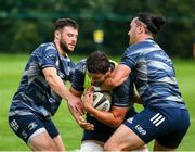 30 July 2020; Max Deegan is tackled by James Lowe and Robbie Henshaw, left, during Leinster Rugby squad training at UCD in Dublin. Professional rugby continues its return in a phased manner, having been suspended since March due to the Irish Government's efforts to contain the spread of the Coronavirus (COVID-19) pandemic. Having had zero positive results from the latest round of PCR testing, the Leinster Rugby players and staff have been cleared to enter the next phase of their return to rugby today which includes a graduated return to contact training. Photo by Conor Sharkey for Leinster Rugby via Sportsfile