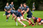 30 July 2020; Ryan Baird is tackled by Sean Cronin and Scott Penny during Leinster Rugby squad training at UCD in Dublin. Professional rugby continues its return in a phased manner, having been suspended since March due to the Irish Government's efforts to contain the spread of the Coronavirus (COVID-19) pandemic. Having had zero positive results from the latest round of PCR testing, the Leinster Rugby players and staff have been cleared to enter the next phase of their return to rugby today which includes a graduated return to contact training. Photo by Conor Sharkey for Leinster Rugby via Sportsfile