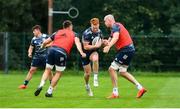 30 July 2020; Ciarán Frawley is tackled by Jack Conan, left, and Devin Toner, right, during Leinster Rugby squad training at UCD in Dublin. Professional rugby continues its return in a phased manner, having been suspended since March due to the Irish Government's efforts to contain the spread of the Coronavirus (COVID-19) pandemic. Having had zero positive results from the latest round of PCR testing, the Leinster Rugby players and staff have been cleared to enter the next phase of their return to rugby today which includes a graduated return to contact training. Photo by Conor Sharkey for Leinster Rugby via Sportsfile