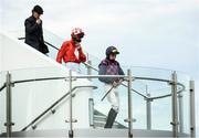 30 July 2020; Jockeys Conor McNamara, right, and Eoin Walsh walk to the parade ring with Clerk of the Course Lorcan Wyer prior to the Guinness Novice Hurdle on day four of the Galway Summer Racing Festival at Ballybrit Racecourse in Galway. Horse racing remains behind closed doors to the public under guidelines of the Irish Government in an effort to contain the spread of the Coronavirus (COVID-19) pandemic. Photo by Harry Murphy/Sportsfile