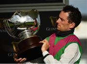 30 July 2020; Jockey Patrick Mullins celebrates with the trophy after victory in the Guinness Galway Hurdle Handicap on Aramon during day four of the Galway Summer Racing Festival at Ballybrit Racecourse in Galway. Horse racing remains behind closed doors to the public under guidelines of the Irish Government in an effort to contain the spread of the Coronavirus (COVID-19) pandemic. Photo by Harry Murphy/Sportsfile