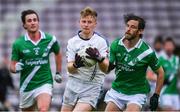 1 August 2020; Liam Ó Conghaile of Mícheál Breathnach's in action against Tomas Gilson, right, and Max Payton of Moycullen during the Galway County Senior Football Championship Group 2 Round 1 match between Moycullen and Mícheál Breathnach's at Pearse Stadium in Galway. GAA matches continue to take place in front of a limited number of people in an effort to contain the spread of the Coronavirus (COVID-19) pandemic. Photo by Piaras Ó Mídheach/Sportsfile