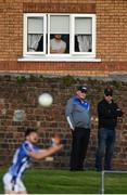 5 August 2020; A spectator watches on from a nearby house during the Dublin County Senior Football Championship Round 2 match between St Vincent's and Ballyboden St Endas at Pairc Naomh Uinsionn in Marino, Dublin. Photo by Stephen McCarthy/Sportsfile