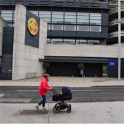 16 August 2020; A lady, pushing a pram, walks past an empty Croke Park Stadium on the original scheduled date of the 2020 GAA Hurling All-Ireland Senior Championship Final. Due to current restrictions laid down by the Irish government to prevent the spread of coronavirus, the dates for the staging of the GAA inter-county season have been pushed back, with the first round of games now due to start in October. The 2020 All-Ireland Senior Hurling Championship was due to be the 133rd staging of the All-Ireland Senior Hurling Championship, the Gaelic Athletic Association's premier inter-county hurling tournament, since its establishment in 1887. For the first time in 96 years the All-Ireland hurling final is now due to be played in December with the 2020 final due on Sunday, December 13th, the same weekend on which Dublin beat Galway in the 1924 final. Photo by Ray McManus/Sportsfile