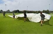 20 August 2020; Groundsmen remove the covers prior to the 2020 Test Triangle Inter-Provincial Series match between Leinster Lightning and Munster Reds at Pembroke Cricket Club in Dublin. Photo by Seb Daly/Sportsfile