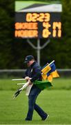 30 August 2020; The scoreboard at the end of the game indicating a score of Skryne 4-14 to Nobber's 11 points as Tony McDonnell collects sideline flags after the Meath County Senior Football Championship match between Skryne and Nobber at Fr Tully Park in Seneschalstown, Meath. Photo by Ray McManus/Sportsfile
