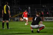 28 August 2020; Mattie Donnelly of Trillick takes a penalty, which he scored, in the penalty shoot-out as his goalkeeper Ryan Kelly and referee Seán Hurson look on during the Tyrone County Senior Football Championship Quarter-Final match between Trillick St Macartan's and Killyclogher St Mary's at Healy Park in Omagh, Tyrone. Photo by Piaras Ó Mídheach/Sportsfile