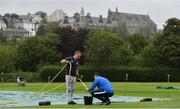 1 September 2020; Head Groundsman Matt Reed, left, and assistant Brandon Kruger drain water from the covers ahead of the 2020 Test Triangle Inter-Provincial Series match between Munster Reds and Leinster Lightning at The Mardyke Cricket Grounds in Cork. Photo by Sam Barnes/Sportsfile
