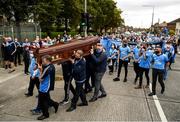 8 September 2020; Members of the funeral procession carry the coffin into the church for the funeral of Dublin GAA supporter Tony Broughan, who was better known as Molly Malone at matches, at the Church Of The Most Precious Blood in Cabra, Dublin. Photo by Harry Murphy/Sportsfile