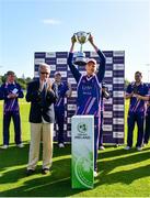 19 September 2020; Jack Tector of YMCA lifts the cup alongside Cricket Ireland president Philip Black during the All-Ireland T20 Cup Final match between YMCA and Donemana at CIYMS Cricket Club in Belfast. Photo by Sam Barnes/Sportsfile