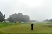 27 September 2020; A member of the greenkeeping staff prepares the 18th green as play was suspended due to adverse weather during day four of the Dubai Duty Free Irish Open Golf Championship at Galgorm Spa & Golf Resort in Ballymena, Antrim. Photo by Brendan Moran/Sportsfile