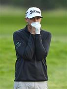 27 September 2020; John Catlin of USA tries to keep his to keep his hands warm while waiting to take his shot on the 18th fairway during day four of the Dubai Duty Free Irish Open Golf Championship at Galgorm Spa & Golf Resort in Ballymena, Antrim. Photo by Brendan Moran/Sportsfile