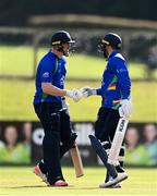 28 September 2020; Graham Hume, left, and Stuart Thompson of North West Warriors bump fists during the Test Triangle Inter-Provincial Series 50 over match between Leinster Lightning and North-West Warriors at Malahide Cricket in Dublin. Photo by Sam Barnes/Sportsfile