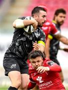 3 October 2020; JJ Hanrahan of Munster is tackled by Steff Evans of Scarlets during the Guinness PRO14 match between Scarlets and Munster at Parc y Scarlets in Llanelli, Wales. Photo by Ben Evans/Sportsfile