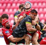 3 October 2020; CJ Stander of Munster is tackled by Blade Thomson, left, and Jonathen Davies of Scarlets during the Guinness PRO14 match between Scarlets and Munster at Parc y Scarlets in Llanelli, Wales. Photo by Darren Griffiths/Sportsfile