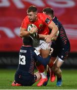 10 October 2020; Alex McHenry of Munster is tackled by Mark Bennett, left, and George Taylor of Edinburgh during the Guinness PRO14 match between Munster and Edinburgh at Thomond Park in Limerick. Photo by Ramsey Cardy/Sportsfile