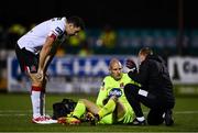 16 October 2020; Dundalk goalkeeper Gary Rogers receives treatment from physiotherapist Danny Miller, right, as team-mate Brian Gartland looks on during the SSE Airtricity League Premier Division match between Dundalk and Bohemians at Oriel Park in Dundalk, Louth. Photo by Harry Murphy/Sportsfile