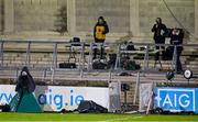 17 October 2020; eirsport match commentary team, from left, co-commentator Marty Clarke, commentator Mike Finnerty and analyst Joe Brolly watch from their positions during the Allianz Football League Division 1 Round 6 match between Dublin and Meath at Parnell Park in Dublin. Photo by Brendan Moran/Sportsfile