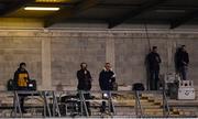 17 October 2020; eirsport match commentary team, from left, co-commentator Marty Clarke, commentator Mike Finnerty, analyst Joe Brolly, presenter Connor Morris and analyst Marc Ó Sé watch from their positions during the Allianz Football League Division 1 Round 6 match between Dublin and Meath at Parnell Park in Dublin. Photo by Ramsey Cardy/Sportsfile