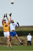 24 October 2020; Colum Duffin of Antrim in action against Sean O'Donovan of Waterford during the Allianz Football League Division 4 Round 7 match between Antrim and Waterford at McGeough Park in Haggardstown, Louth. Photo by David Fitzgerald/Sportsfile
