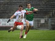 25 October 2020; Darragh Canavan of Tyrone shoots to score his side's second goal as Oisín Mullin of Mayo closes in during the Allianz Football League Division 1 Round 7 match between Mayo and Tyrone at Elverys MacHale Park in Castlebar, Mayo. Photo by Piaras Ó Mídheach/Sportsfile