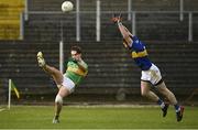 25 October 2020; Darragh Rooney of Leitrim kicks a point under pressure from Jimmy Feehan of Tipperary during the Allianz Football League Division 3 Round 7 match between Leitrim and Tipperary at Avantcard Páirc Sean Mac Diarmada in Carrick-on-Shannon, Leitrim. Photo by Seb Daly/Sportsfile