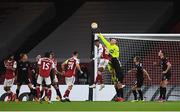 29 October 2020; Dundalk goalkeeper Gary Rogers punches the ball clear as he is challenged by Joe Willock of Arsenal during the UEFA Europa League Group B match between Arsenal and Dundalk at the Emirates Stadium in London, England. Photo by Ben McShane/Sportsfile