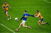 1 November 2020; Conor Sweeney of Tipperary scores his side's ninth point despite the efforts of Kevin Harnett of Clare during the Munster GAA Football Senior Championship Quarter-Final match between Tipperary and Clare at Semple Stadium in Thurles, Tipperary. Photo by Diarmuid Greene/Sportsfile