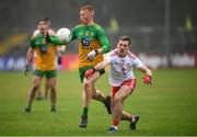 1 November 2020; Oisin Gallen of Donegal in action against Niall Sludden of Tyrone during the Ulster GAA Football Senior Championship Quarter-Final match between Donegal and Tyrone at MacCumhaill Park in Ballybofey, Donegal. Photo by Stephen McCarthy/Sportsfile
