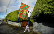 8 November 2020; A local resident puts up flags prior to the Connacht GAA Football Senior Championship Semi-Final match between Roscommon and Mayo at Dr Hyde Park in Roscommon. Photo by Harry Murphy/Sportsfile