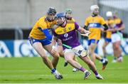 14 November 2020; Kevin Foley of Wexford in action against Colin Guilfoyle of Clare during the GAA Hurling All-Ireland Senior Championship Qualifier Round 2 match between Wexford and Clare at MW Hire O'Moore Park in Portlaoise, Laois. Photo by Matt Browne/Sportsfile