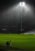 14 November 2020; Michael Breen of Tipperary leaves the pitch amid heavy rain, accompanied by local Tipperary photographer Bridget Delaney, after the GAA Hurling All-Ireland Senior Championship Qualifier Round 2 match between Cork and Tipperary at LIT Gaelic Grounds in Limerick. Photo by Brendan Moran/Sportsfile