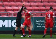 15 November 2020; Luke Byrne, centre, of Shelbourne receives a red card from referee Neil Doyle, resulting in a penalty for Longford Town, during the SSE Airtricity League Play-off Final match between Shelbourne and Longford Town at Richmond Park in Dublin. Photo by Ben McShane/Sportsfile