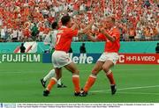 4 July 1994; Holland players Denis Bergkamp is congratulated by team-mate Marc Overmars on scoring their sides goal as Terry Phelan, (3) Republic of Ireland, looks on. FIFA World Cup Finals, Republic of Ireland v Holland, Orange Bowl, Orlando, Florida, USA. Picture credit; David Maher / SPORTSFILE