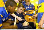 30 January 2004; Dublin Footballer and Chief Executive of the GPA Dessie Farrell signs autographs for pupils from Cnoc Mhuire, Senior School, Killinarden, Tallaght, at the presentation of a full kit of gear to the boys and girls Gaelic teams by the C&C group( Club Energise). Picture credit; Matt Browne / SPORTSFILE *EDI*