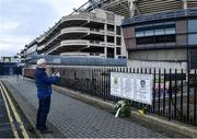 21 November 2020; Dublin supporter Paul Nolan, from Clondalkin, Co Dublin, takes a photo of a memorial on Jones' Road, ahead of the GAA Bloody Sunday Commemoration at Croke Park in Dublin. On this day 100 years ago, Sunday 21 November 1920, an attack by Crown Forces on the attendees at a challenge Gaelic Football match between Dublin and Tipperary during the Irish War of Independence resulted in 14 people being murdered. Along with the 13 supporters that lost their lives that day a Tipperary footballer, Michael Hogan, also died. The main stand in Croke Park, the Hogan Stand, was subsequently named after him. Photo by Dáire Brennan/Sportsfile Photo by Daire Brennan/Sportsfile