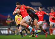 30 November 2020; Dan Goggin of Munster on his way to scoring his side's first try despite the tackle of Junior Laloifi of Zebre during the Guinness PRO14 match between Munster and Zebre at Thomond Park in Limerick. Photo by Ramsey Cardy/Sportsfile