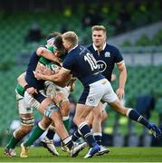 5 December 2020; Caelan Doris of Ireland is tackled by Jamie Ritchie, left, and Jaco van der Walt of Scotland during the Autumn Nations Cup match between Ireland and Scotland at the Aviva Stadium in Dublin. Photo by Seb Daly/Sportsfile