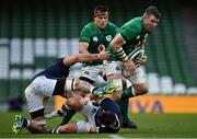 5 December 2020; Peter O'Mahony of Ireland evades the tackles of Scotland's Blade Thomson, left, and Ali Price during the Autumn Nations Cup match between Ireland and Scotland at the Aviva Stadium in Dublin. Photo by Seb Daly/Sportsfile